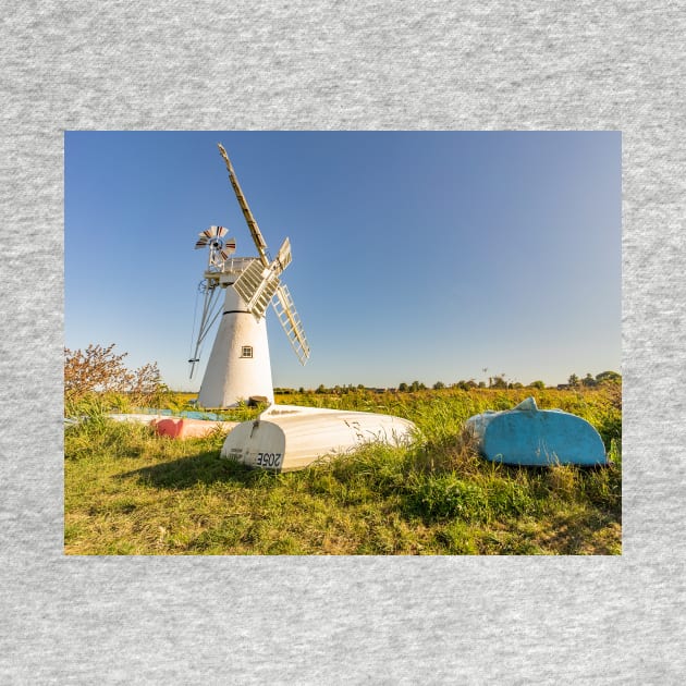 Day boats upside down on the riverbank with Thurne Mill in the background by yackers1